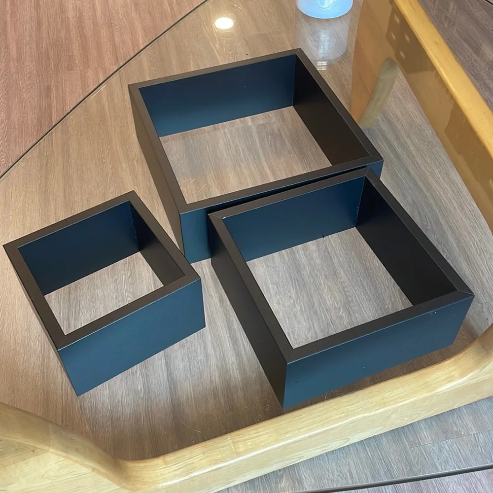 3 black shelving units